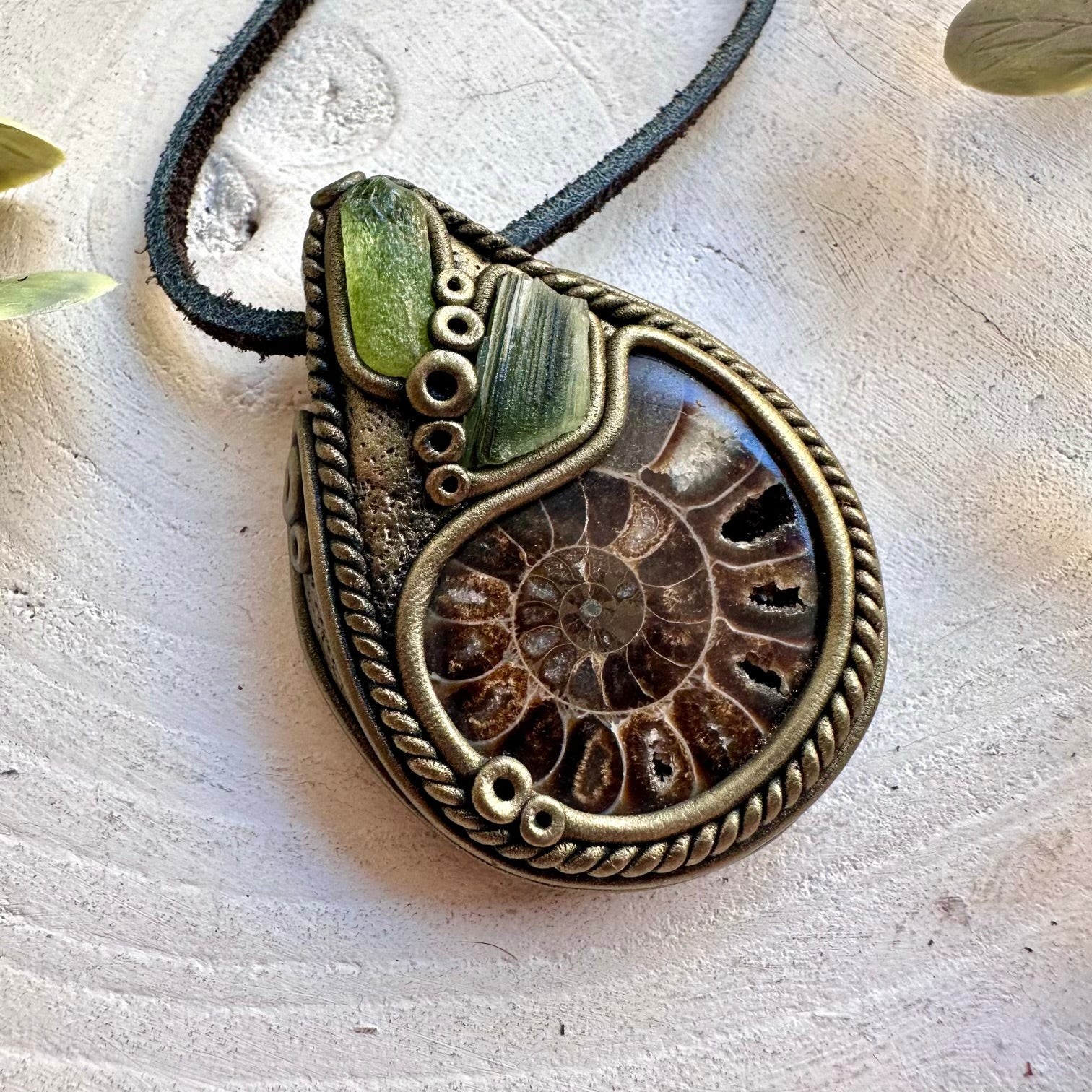 Handmade gemstone necklace combining an Ammonite fossil with Peridot and natural Moldavite.