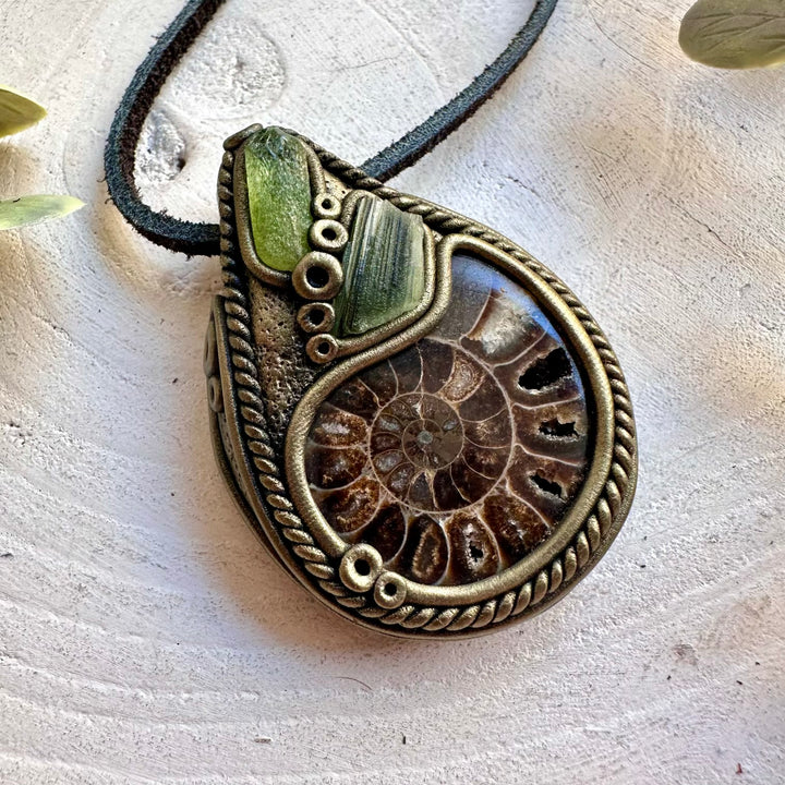 Handmade gemstone necklace combining an Ammonite fossil with Peridot and natural Moldavite.