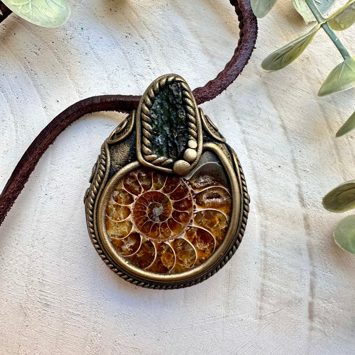 Spiritual jewelry combining raw moldavite and ammonite fossil