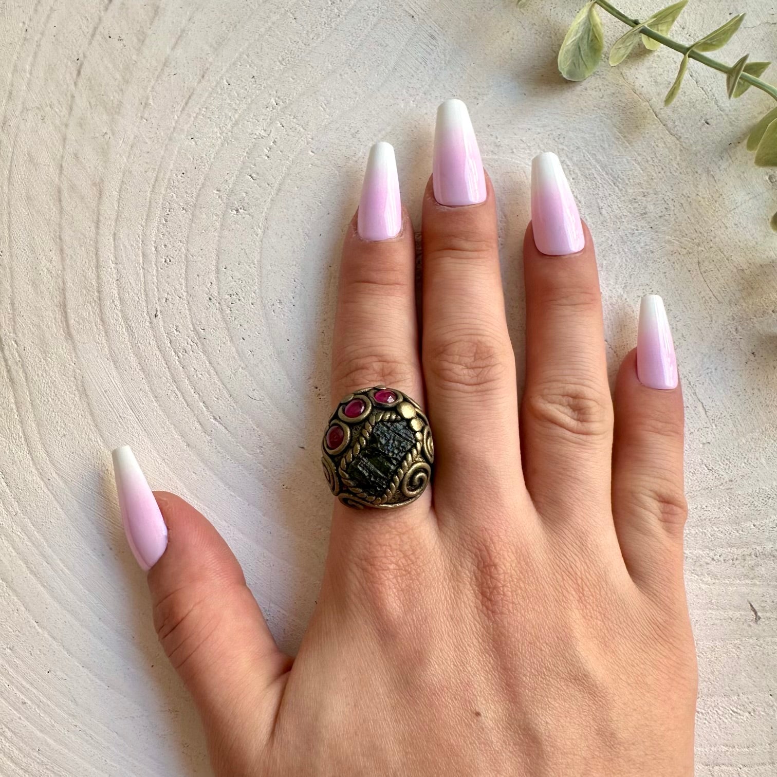 Handmade crystal jewelry showcasing Moldavite with deep red Rhodolite Garnet accents.