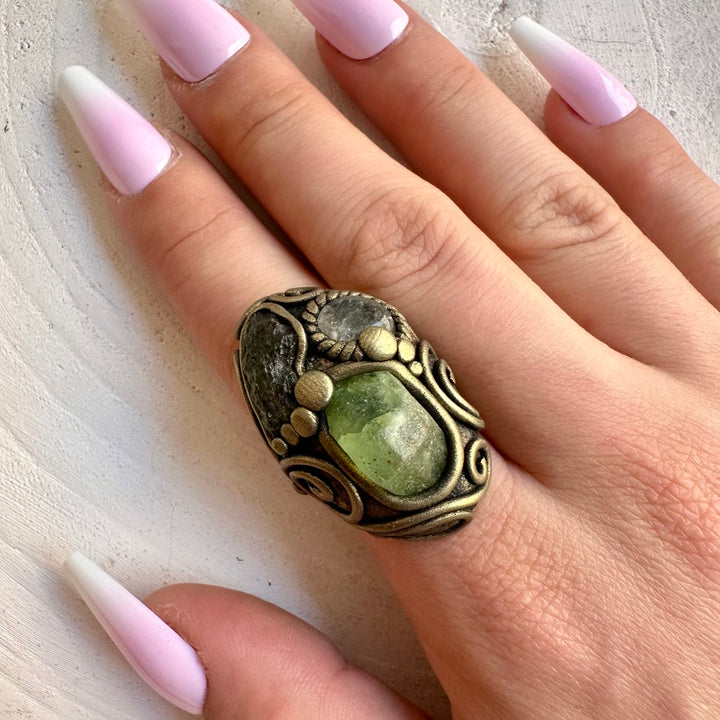 Handmade gemstone ring combining natural Moldavite with vibrant green Peridot and Clear Topaz.