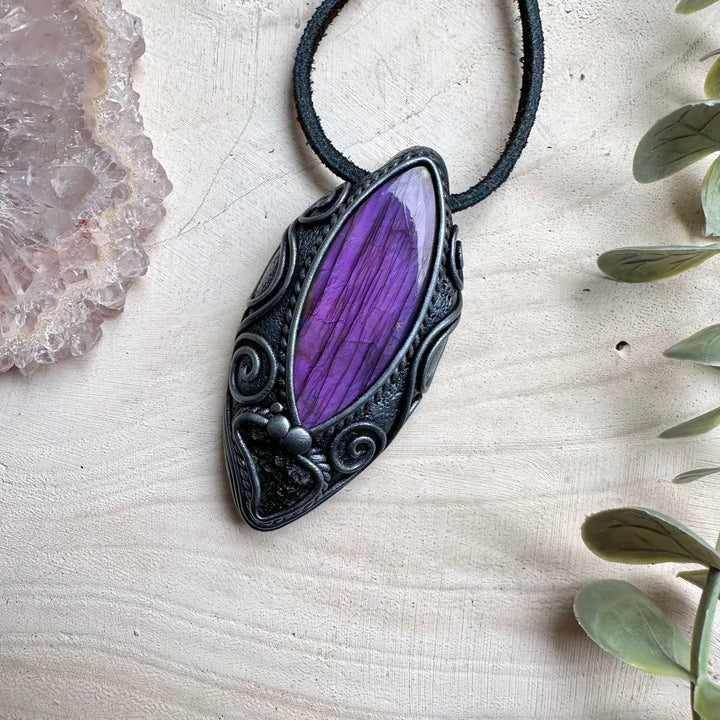 Purple labradorite paired with raw moldavite in a necklace