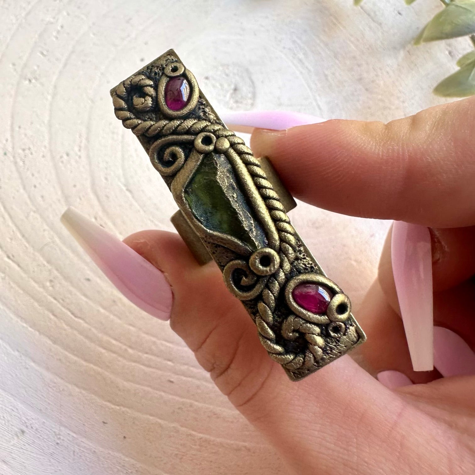 Artisan ring featuring Moldavite and Rhodolite Garnet in a unique handmade setting.
