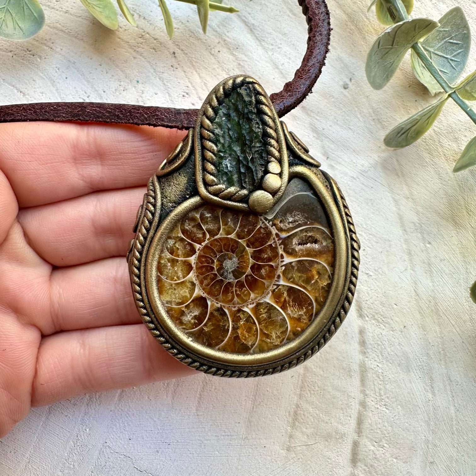 Natural ammonite paired with raw moldavite in a necklace