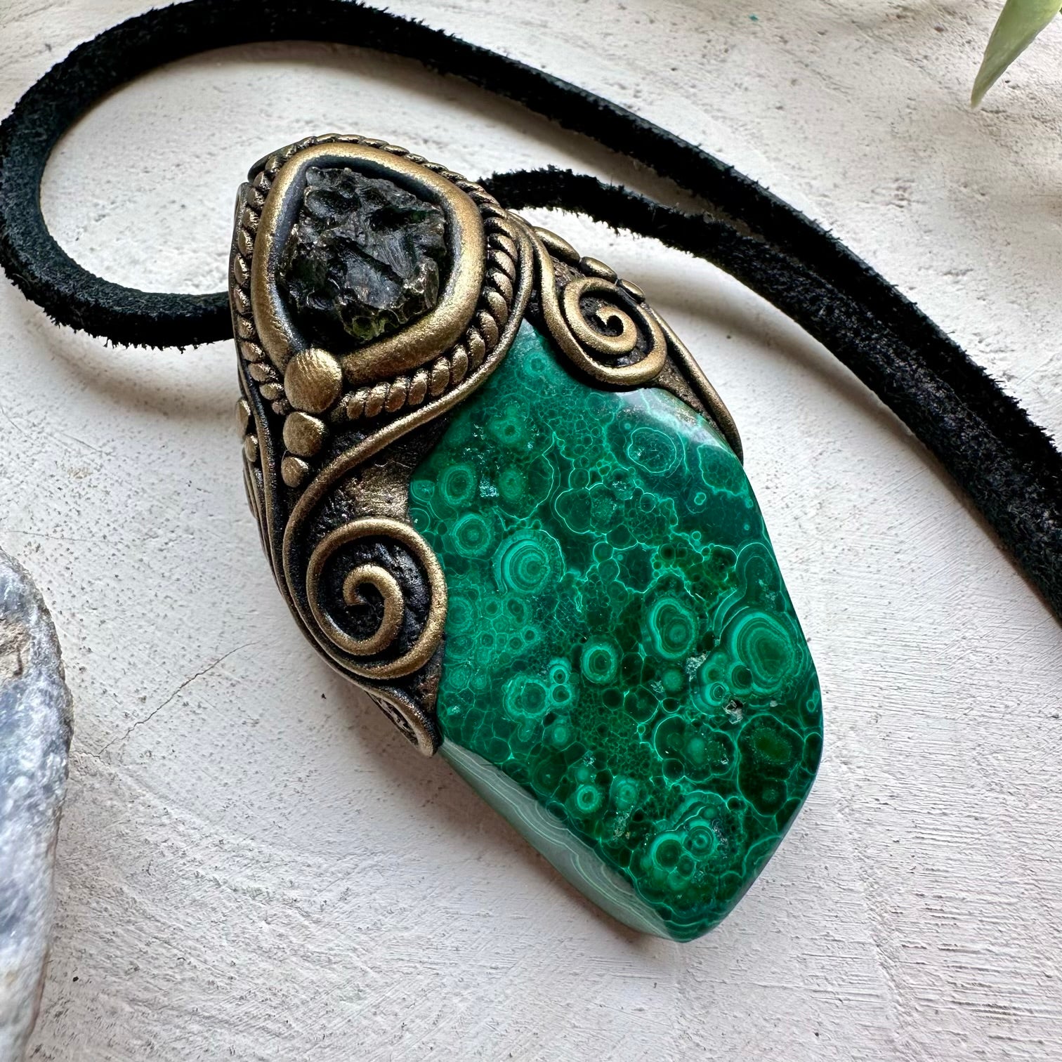 Natural malachite paired with moldavite in a necklace