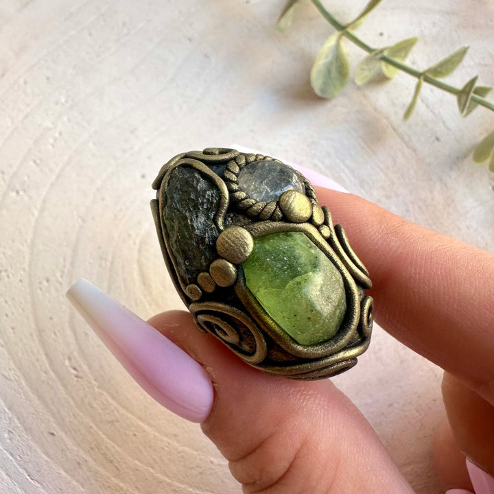 Handmade Moldavite with Peridot and Clear Topaz adjustable ring featuring genuine natural gemstones in a unique artisan design. A one of a kind healing crystal ring combining vibrant green stones with sparkling Clear Topaz, inspired by transformation, renewal, clarity and personal growth.