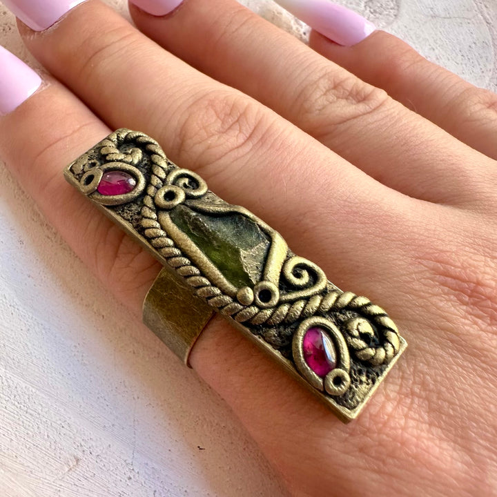 Handmade healing crystal ring featuring Moldavite and Rhodolite Garnet.