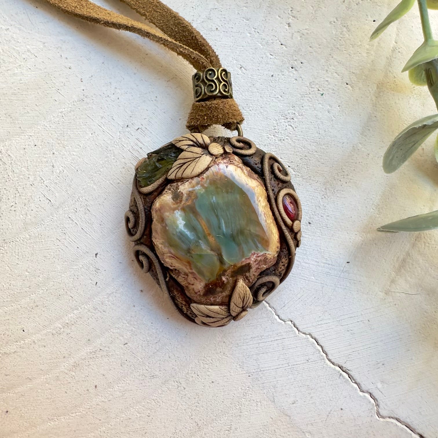 Handmade unisex crystal necklace featuring petrified wood and moldavite