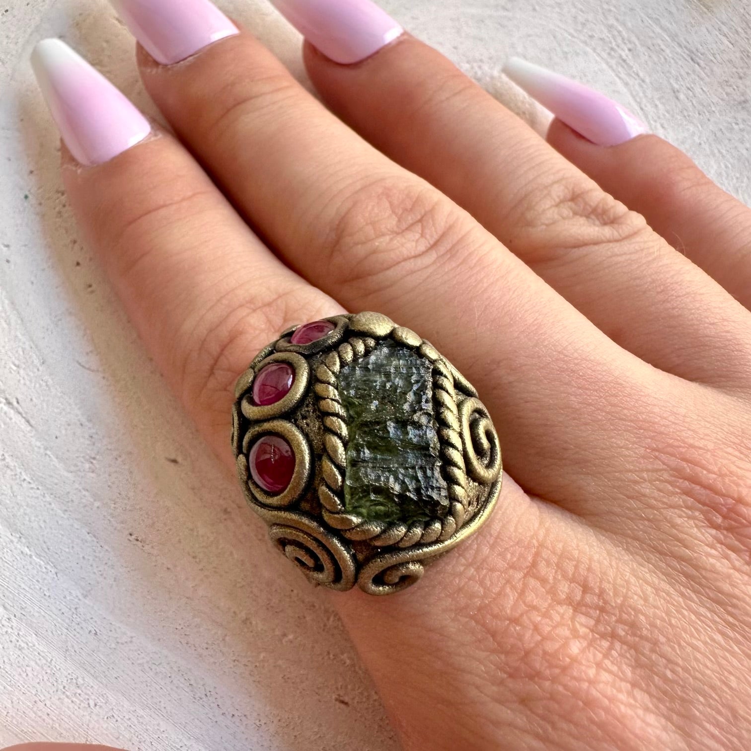 Handmade adjustable ring featuring natural Moldavite and Rhodolite Garnet gemstones.