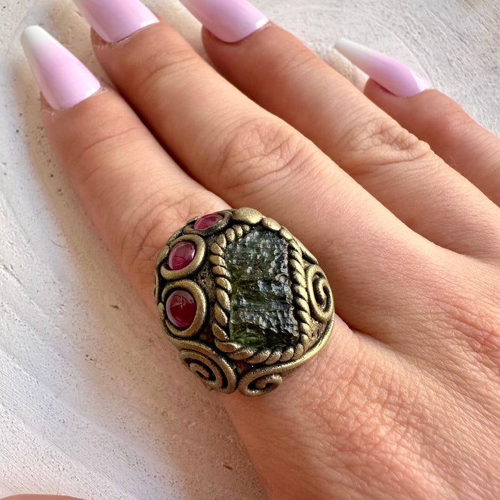 Handmade adjustable ring featuring natural Moldavite and Rhodolite Garnet gemstones.