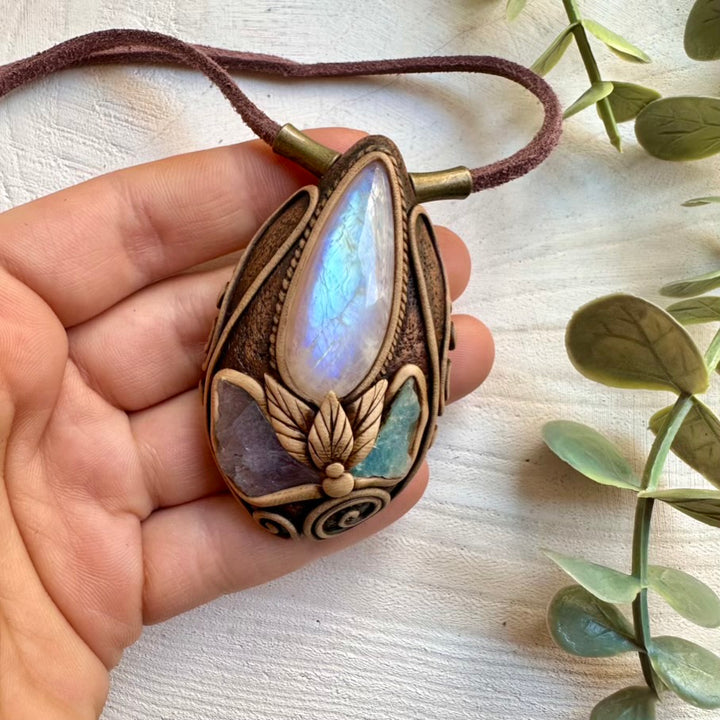 Healing crystal necklace featuring rainbow moonstone and raw tanzanite