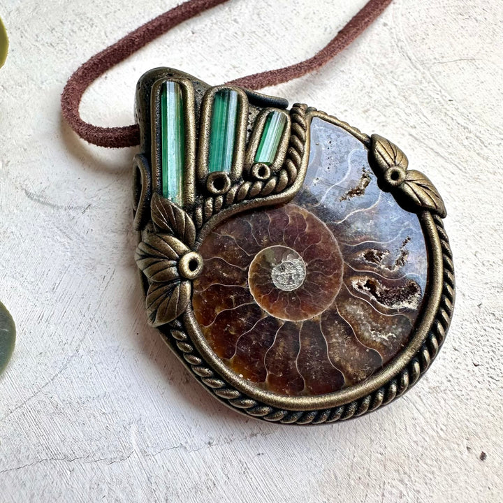 Mystical fossil crystal necklace with green tourmaline gemstones and ammonite shell pendant