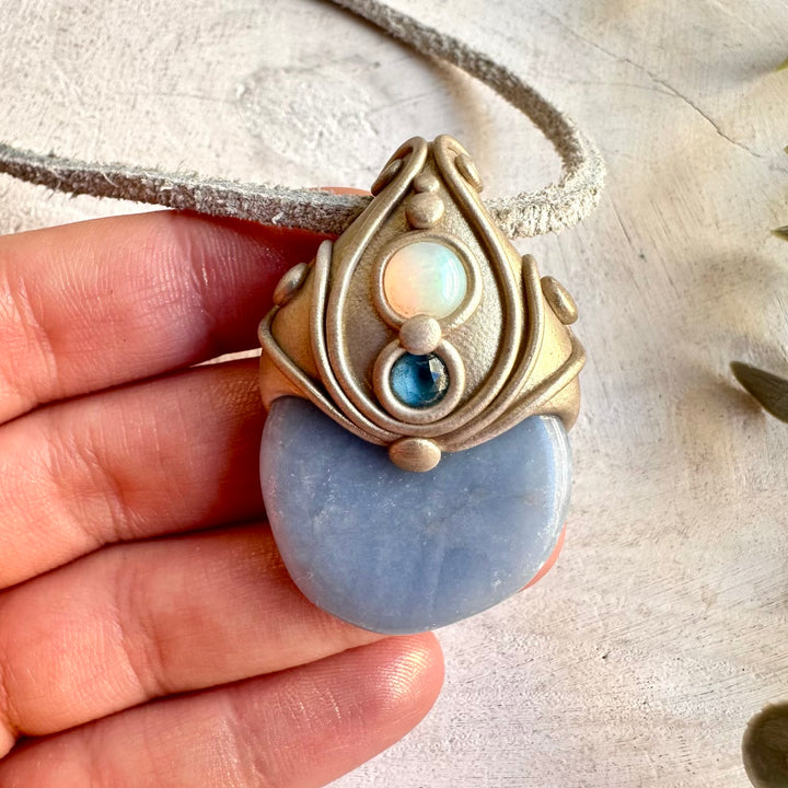 Unique Angelite talisman necklace adorned with London Blue Topaz and colorful Opal flashes.