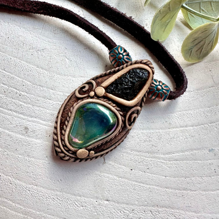 Crystal pendant necklace crafted with genuine Aqua Aura Quartz and Moldavite gemstones.