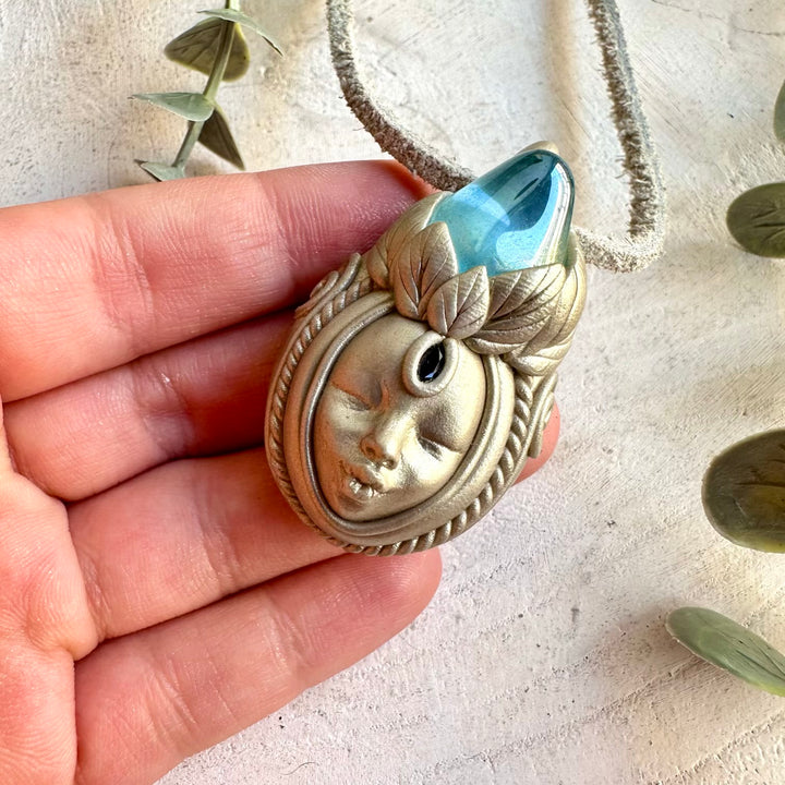 Handmade spiritual jewelry featuring luminous Aqua Aura Quartz and Blue Sapphire in a Goddess design.
