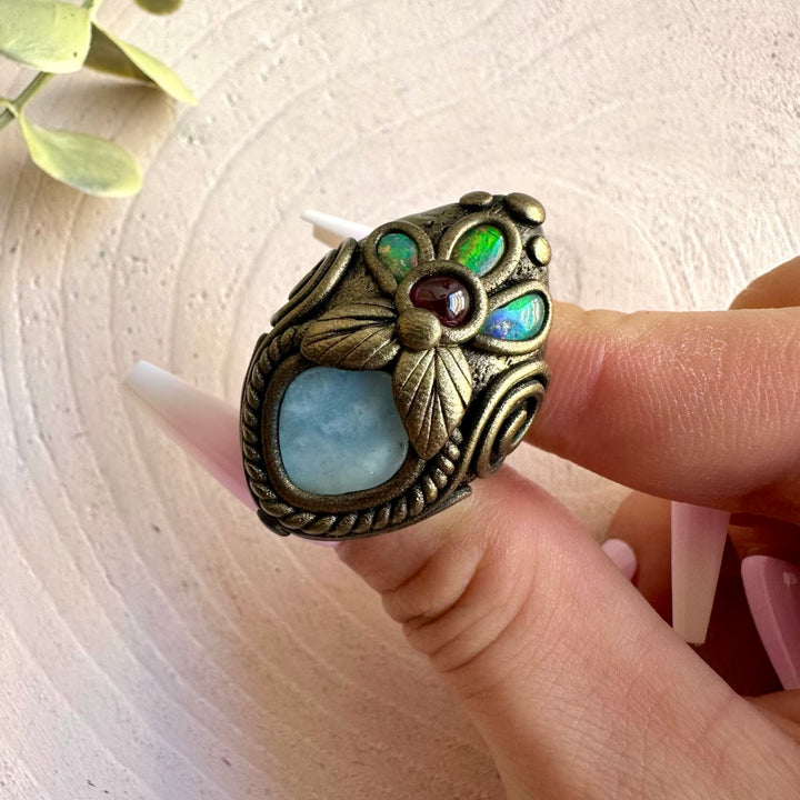 Spiritual gemstone ring handcrafted with Aquamarine, Ethiopian Opal and Rhodolite Garnet.