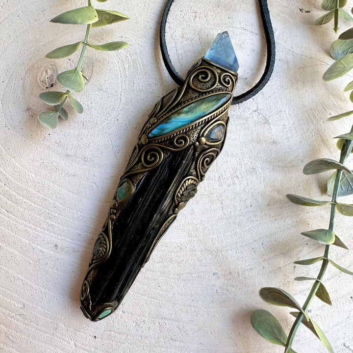 Natural gemstone pendant featuring Labradorite, Raw Ethiopian Opal and Moldavite alongside Black Tourmaline.