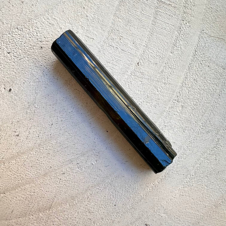 Raw green tourmaline mineral crystal