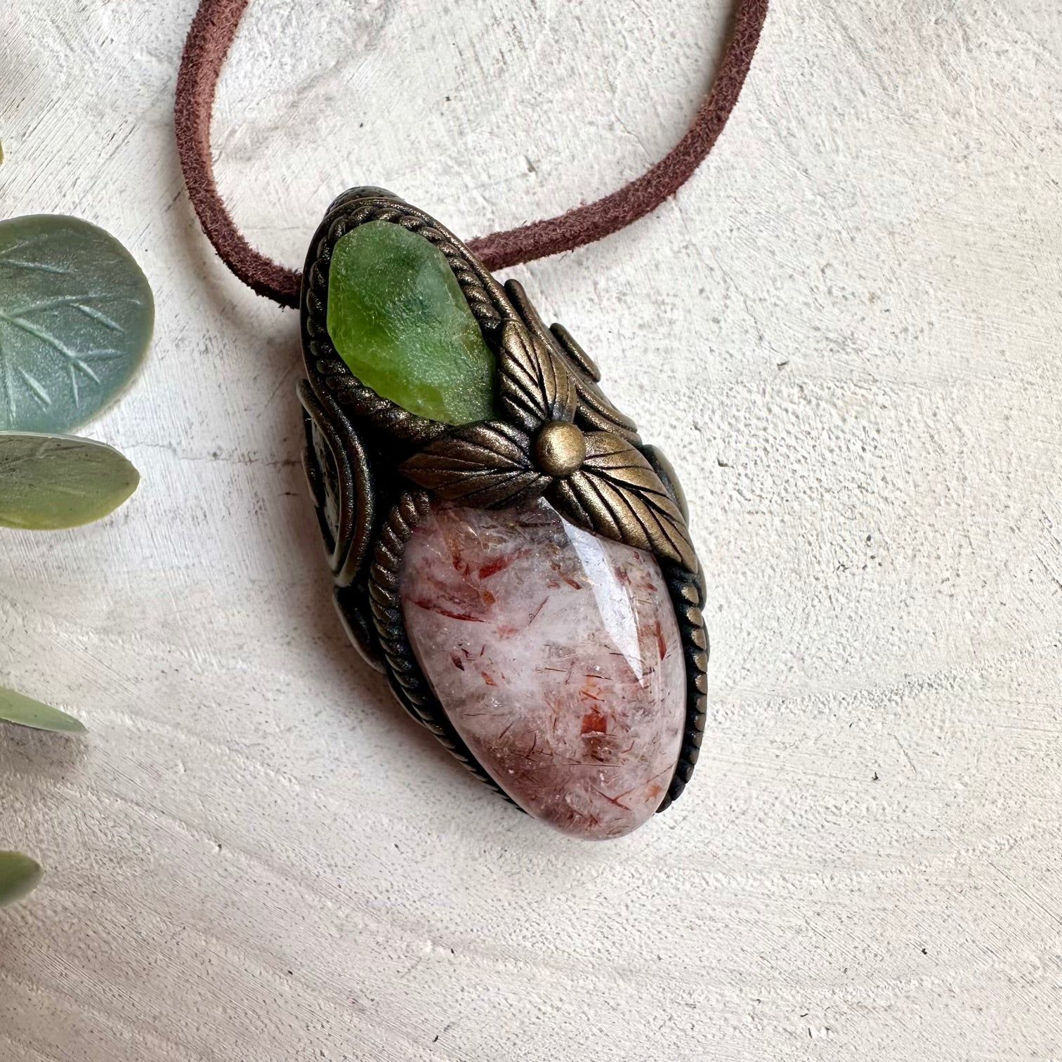 Spiritual jewelry necklace featuring Hematite Quartz and Peridot gemstones for protection, abundance, and emotional healing.
