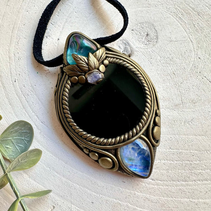 Artisan handmade pendant featuring Black Obsidian Mirror, Rainbow Moonstone and a raw Tanzanite gemstone.