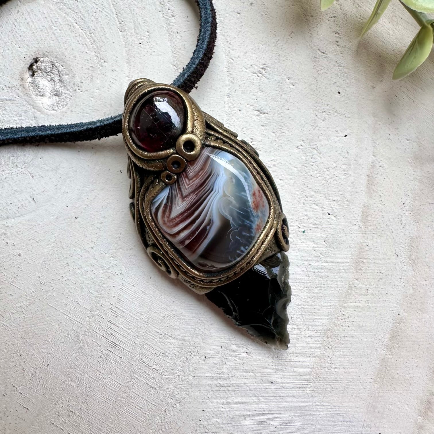 Obsidian arrowhead paired with botswana agate and rhodolite garnet