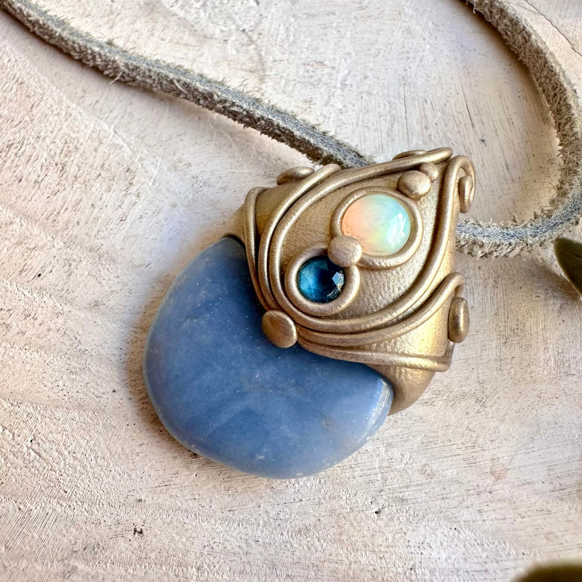 Colorful Ethiopian Opal adds iridescent flashes to this handmade Angelite and London Blue Topaz necklace.