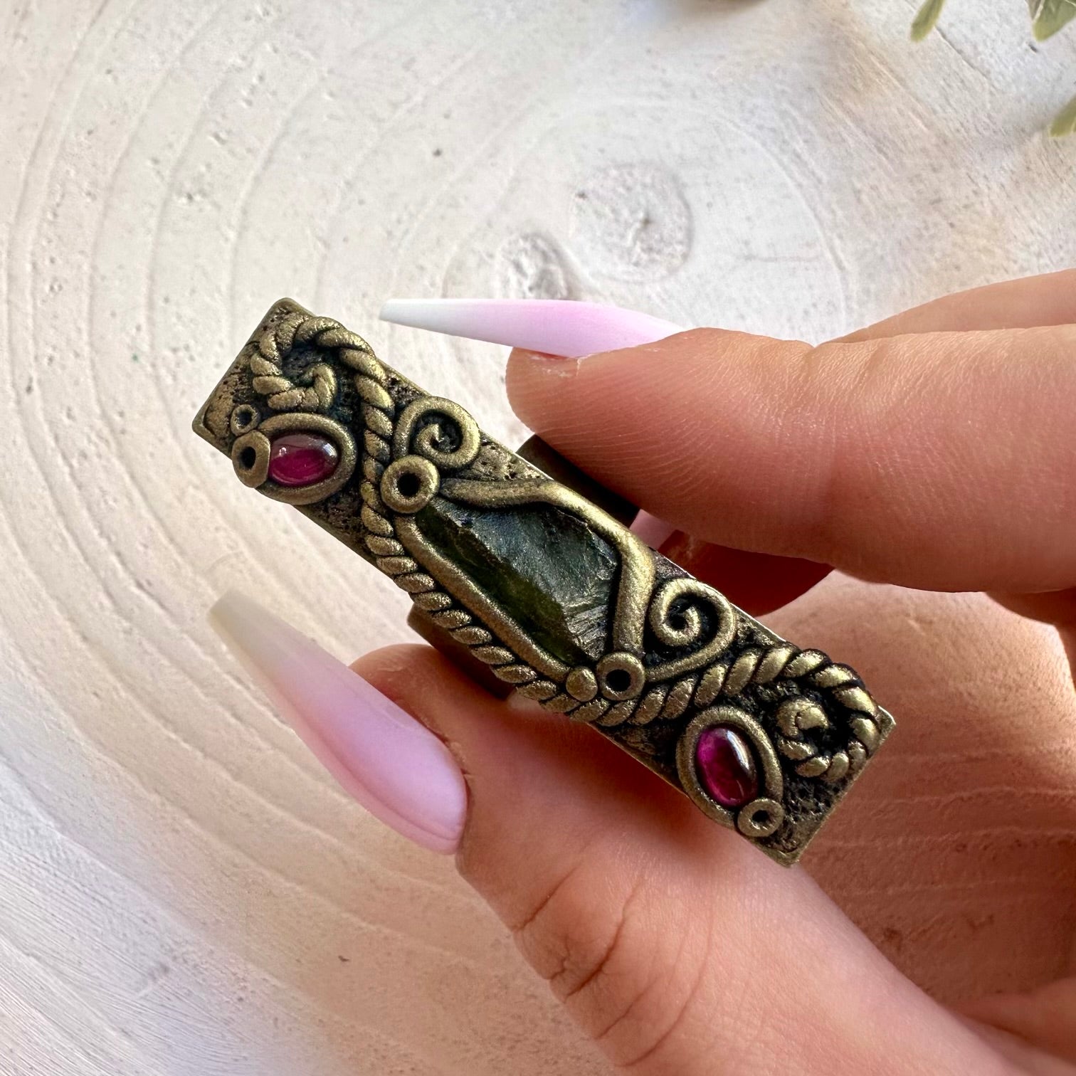 One of a kind Moldavite ring with deep red Rhodolite Garnet accents.
