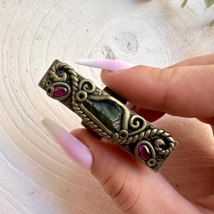 One of a kind Moldavite ring with deep red Rhodolite Garnet accents.