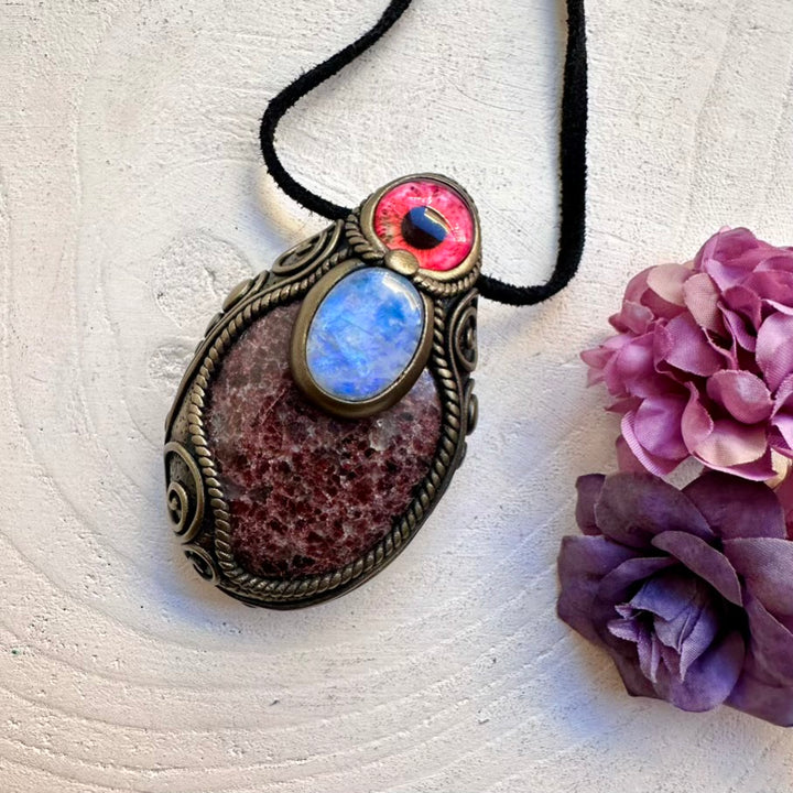 Artisan handcrafted protection amulet necklace with natural imperfect Red Garnet crystal and luminous Rainbow Moonstone eye talisman.