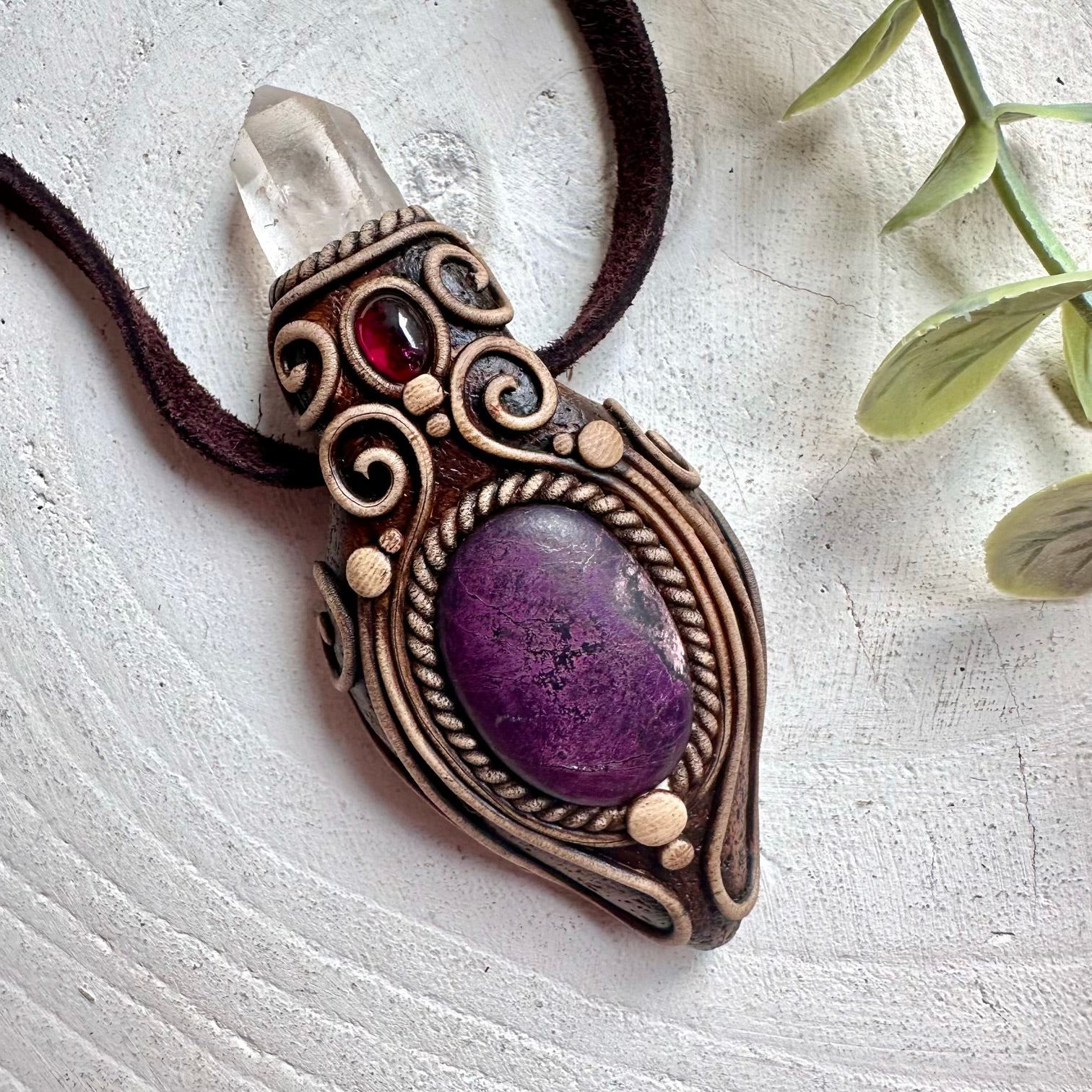 Spiritual crystal necklace featuring Sugilite, Clear Quartz and Rhodolite Garnet for protection and balance