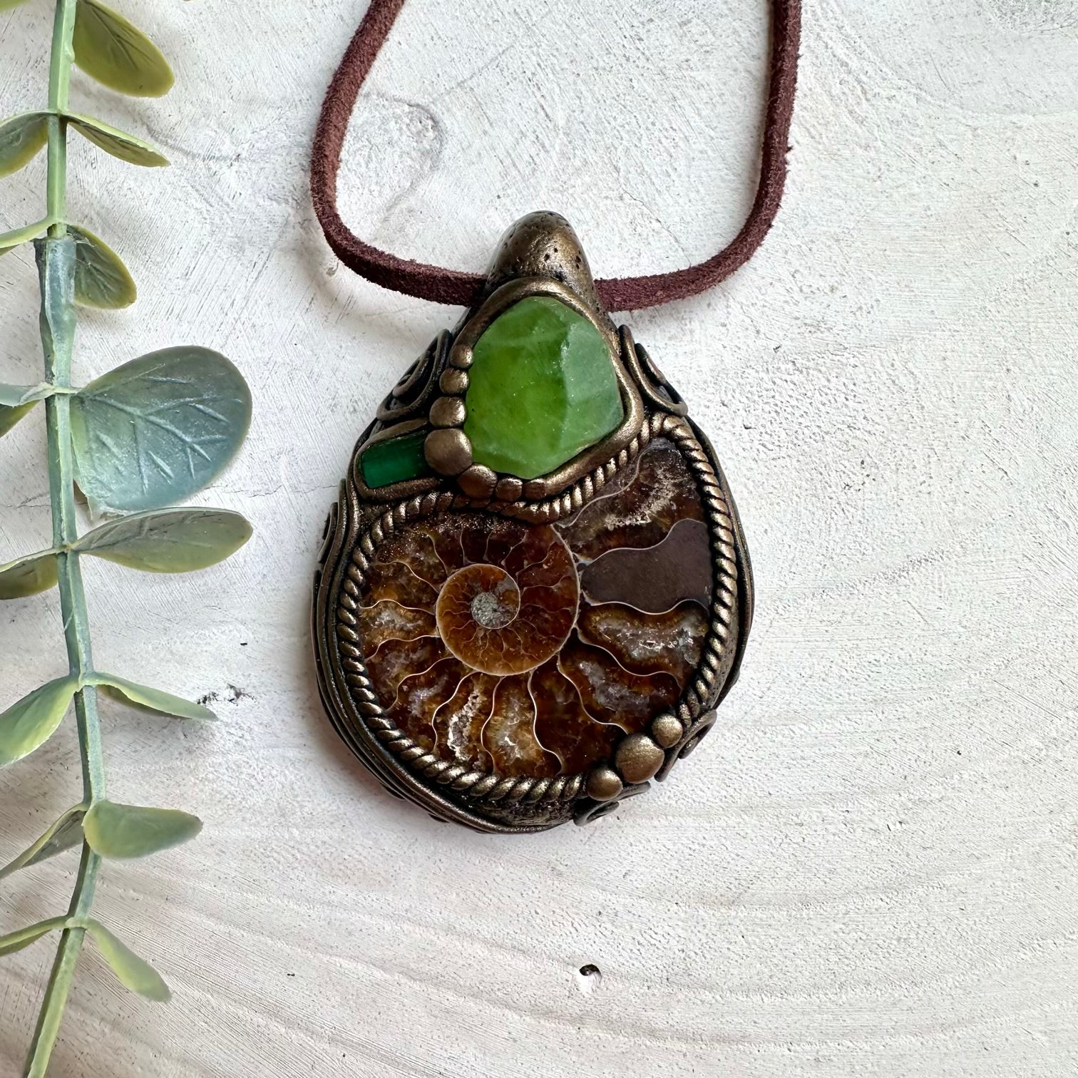 Peridot and green tourmaline crystal pendant necklace with ammonite fossil and healing gemstone energy