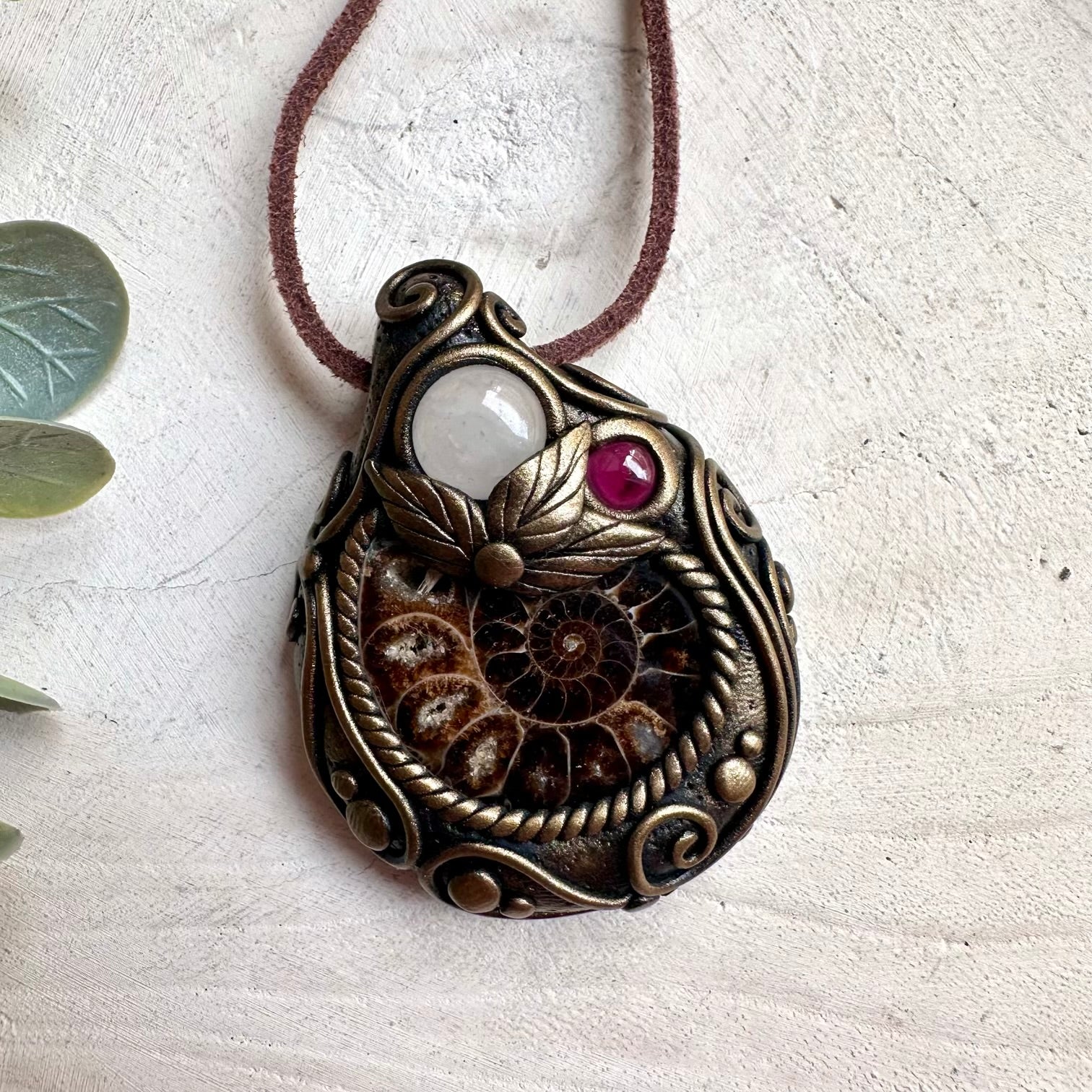 Crystal pendant necklace with Ammonite and Clear Quartz designed for clarity, grounding, and positive energy.