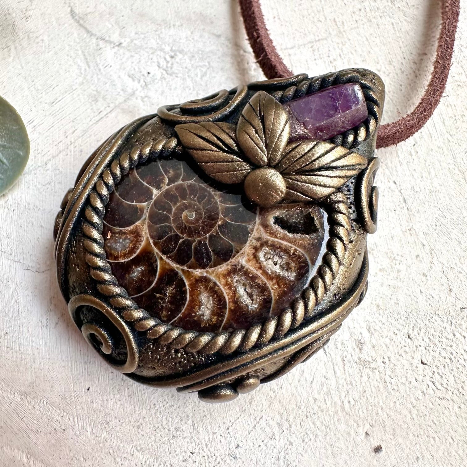 Crystal pendant necklace with Ammonite and Ruby designed for confidence, passion, and spiritual awakening.