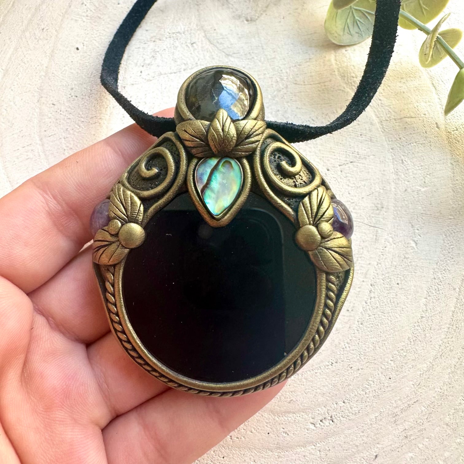 Metaphysical crystal pendant necklace featuring Black Obsidian Mirror with Abalone Seashell.