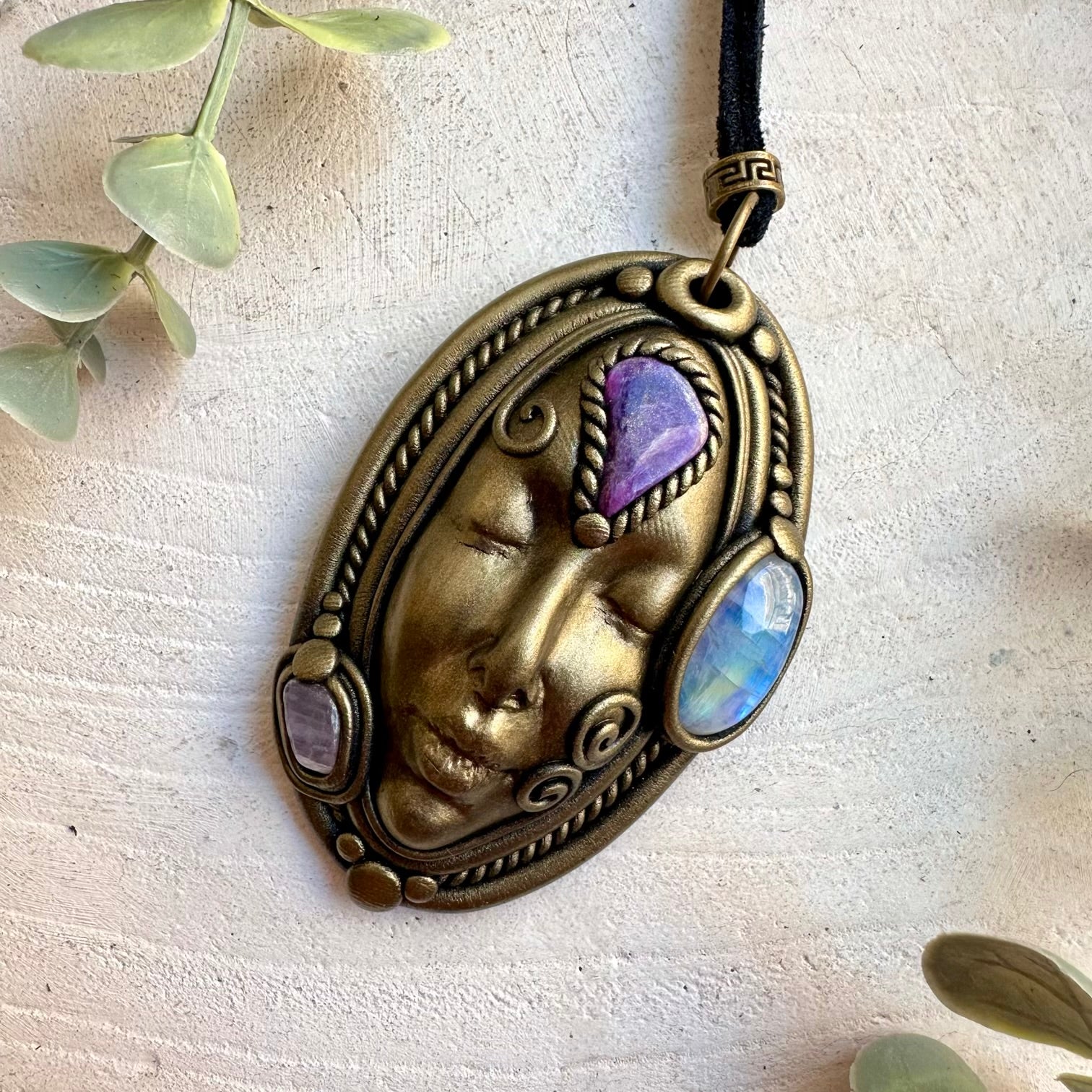Handmade spiritual pendant combining Rainbow Moonstone with Charoite and Kunzite crystals.
