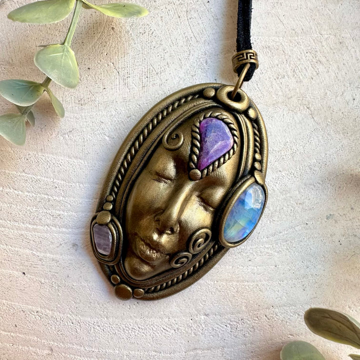 Handmade spiritual pendant combining Rainbow Moonstone with Charoite and Kunzite crystals.