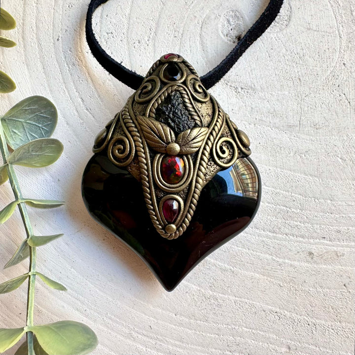 Handmade spiritual necklace featuring Moldavite, Smoky Quartz and Rhodolite Garnet.