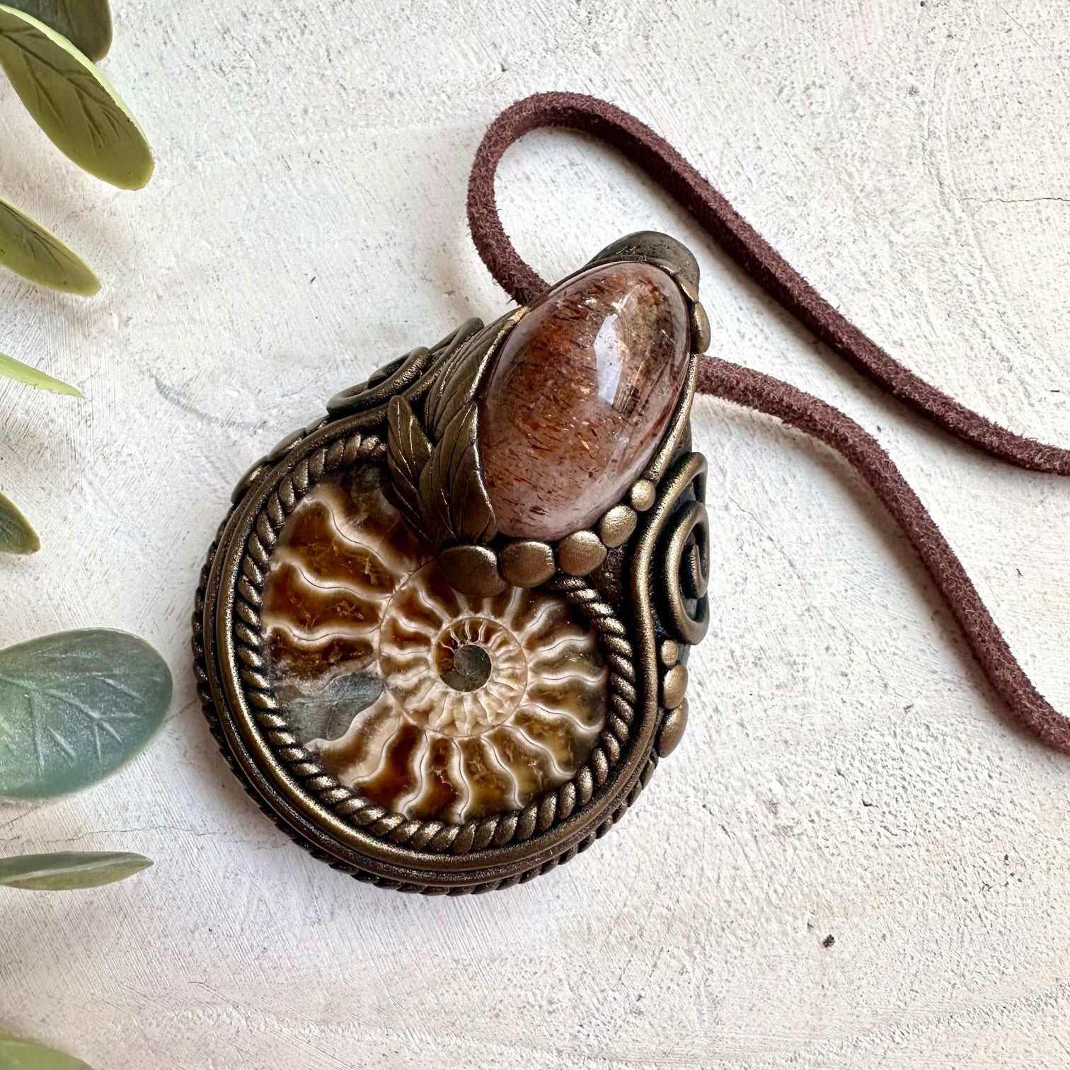 Raw ammonite fossil crystal necklace featuring hematite quartz and earthy spiritual jewelry style
