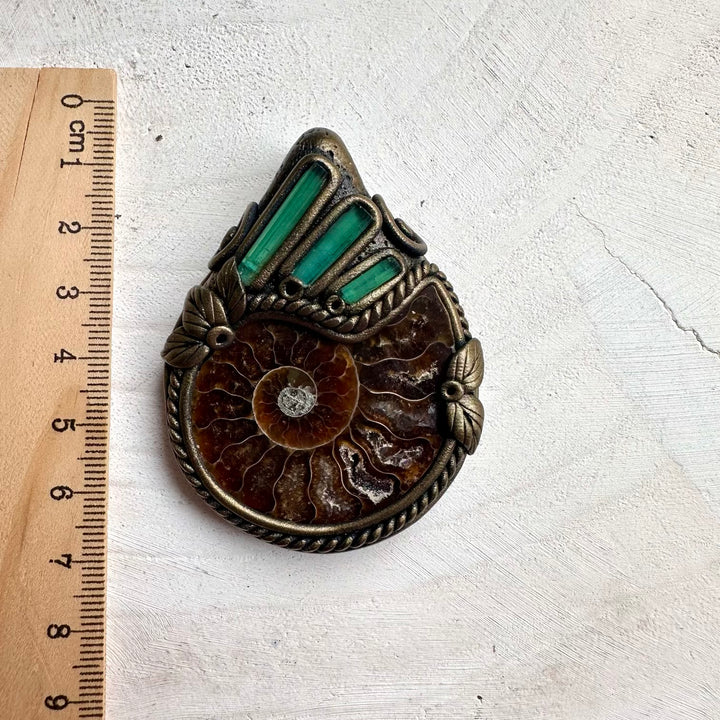 Healing stone necklace featuring ammonite fossil and green tourmaline crystals for positive energy