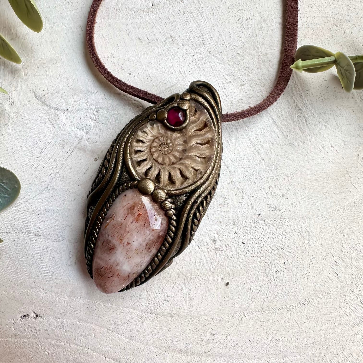 Raw ammonite healing crystal necklace featuring hematite quartz and rhodolite garnet gemstones