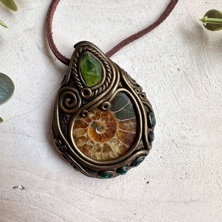 Raw crystal necklace with natural ammonite fossil, black opal, and peridot gemstone accents