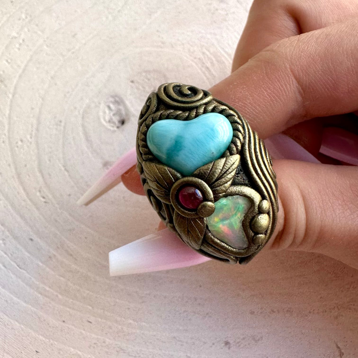 Handmade statement ring showcasing natural Larimar, Ethiopian Opal and Rhodolite Garnet.