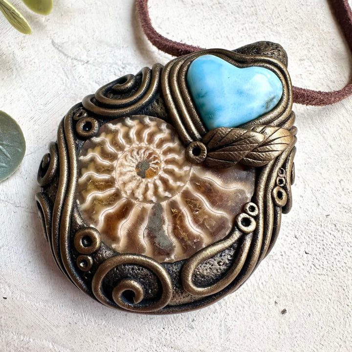 Raw healing crystal necklace featuring larimar heart gemstone and ammonite fossil pendant