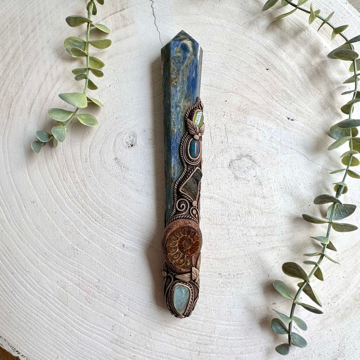 One of a kind spiritual crystal wand showcasing blue Kyanite alongside Ammonite, Raw Moldavite and colorful natural gemstones.