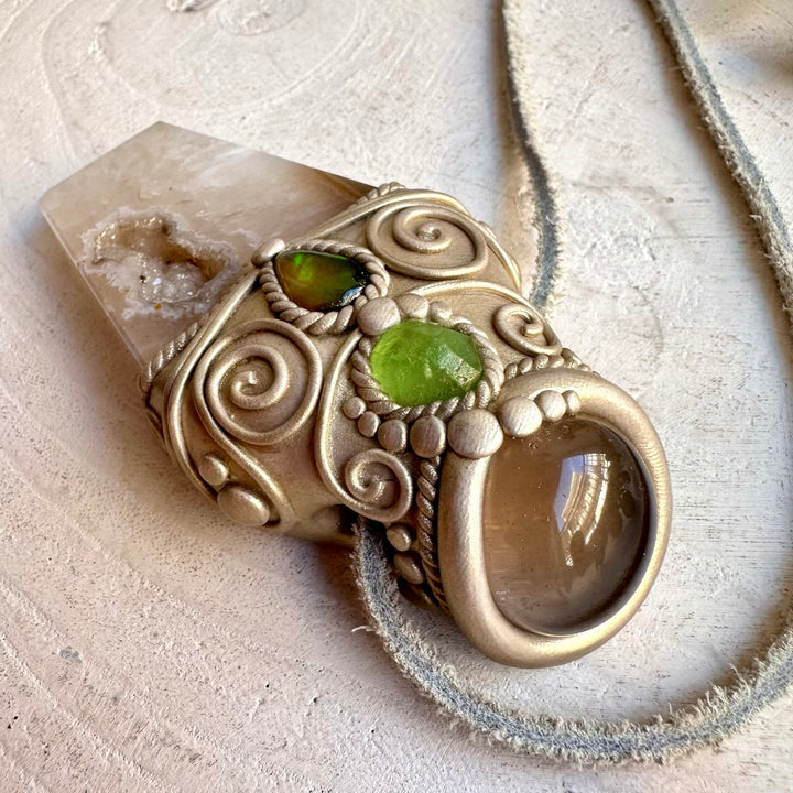 Handmade Agate Point with Smoky Quartz, Raw Peridot and Black Ethiopian Opal wand / pendant necklace, a one of a kind healing crystal jewelry piece combining earthy Agate and Smoky Quartz with vibrant Raw Peridot and mysterious Black Ethiopian Opal.
