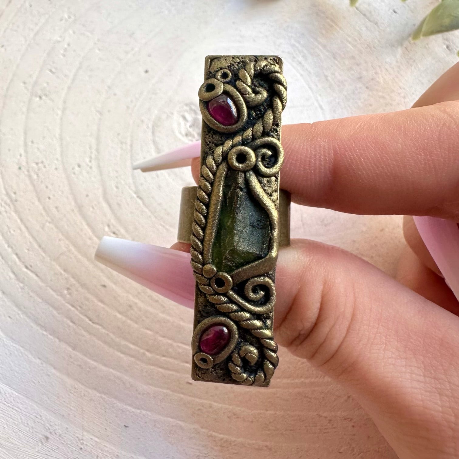 Handmade gemstone ring combining green Moldavite with rich red Rhodolite Garnet.