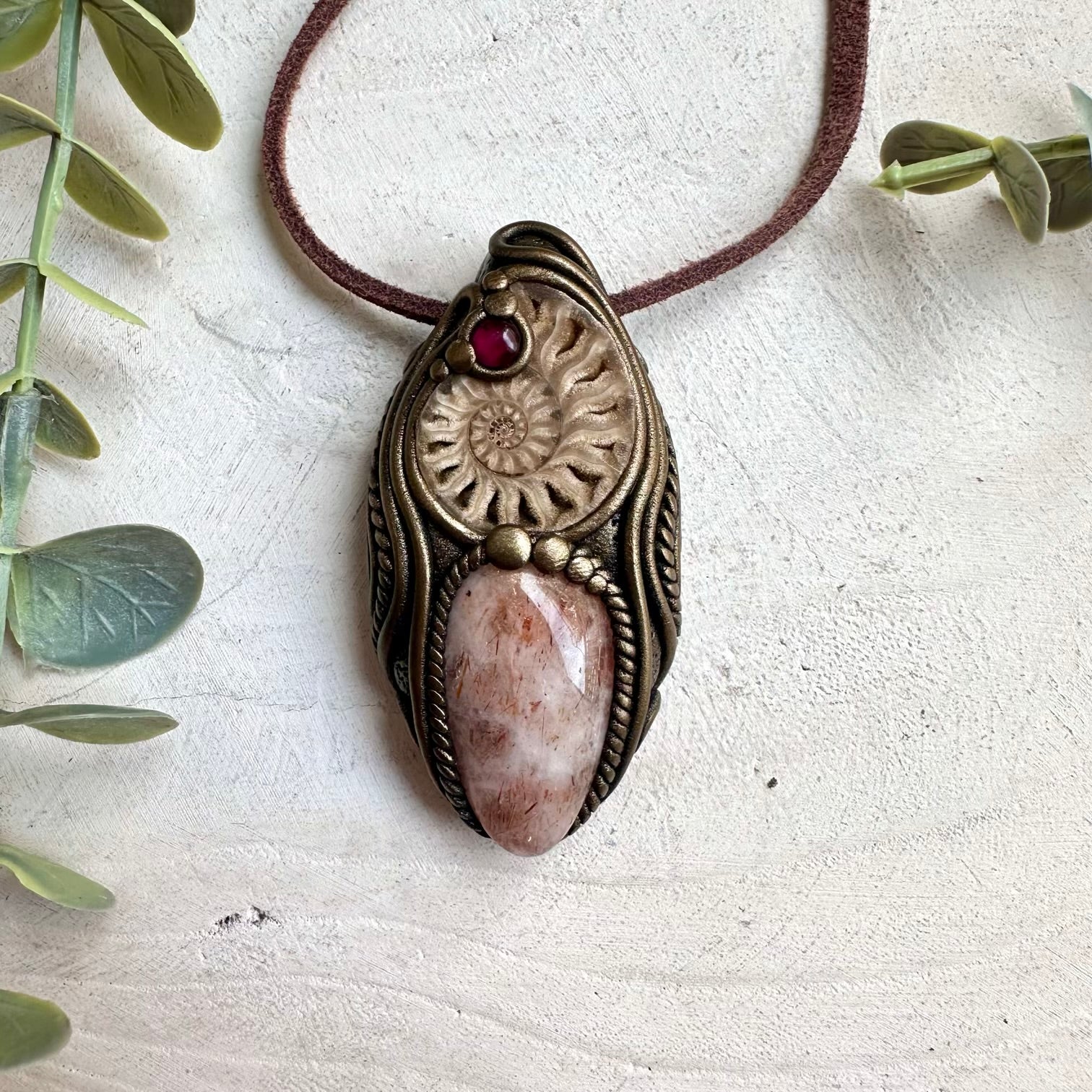Rhodolite garnet spiritual crystal necklace with ammonite fossil and hematite quartz pendant details