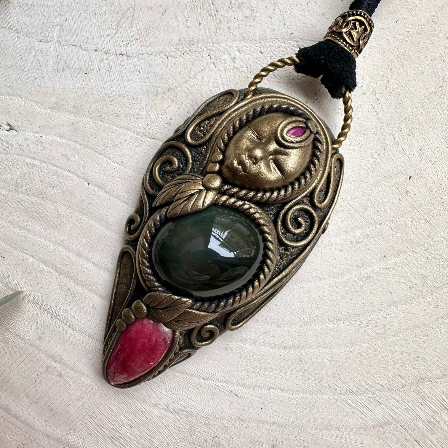 Rainbow obsidian paired with rhodonite and ruby in a necklace