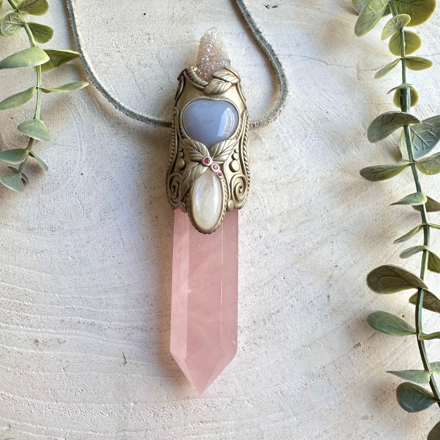 Handmade crystal wand pendant necklace featuring Rose Quartz, Angel Aura Spirit Quartz, Moonstone, Blue Chalcedony Heart and Ruby.