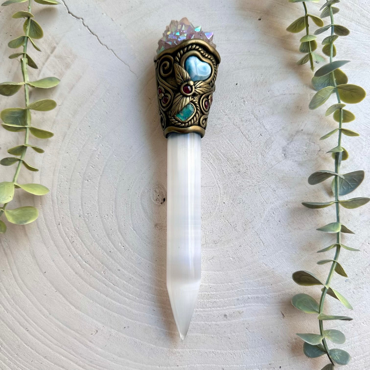 Handmade Selenite crystal wand featuring Angel Aura Spirit Quartz, Ethiopian Opal, Larimar Heart and Rhodolite Garnet. A one of a kind energy healing tool combining luminous Selenite with iridescent crystals and natural gemstones, created for meditation, intention setting, energy work and spiritual practice.